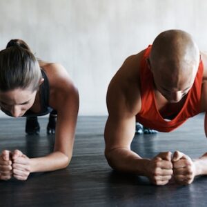 Keeping each other focussed during a workout Shot of a young man and woman working out