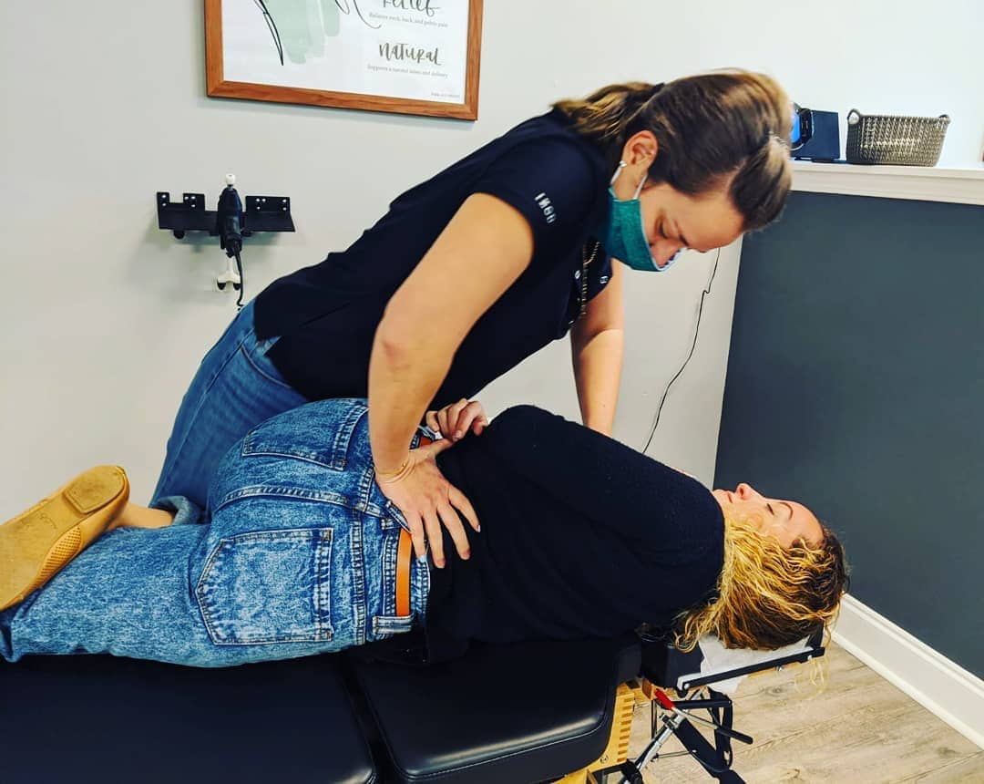 chiropractor adjusting patient